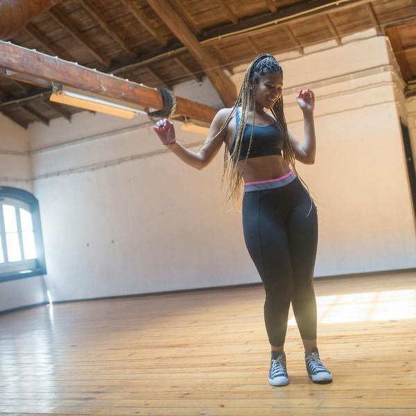 Woman feeling energetic and vibrant in a bright, open space.